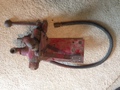 Farmall Cub Hydraulic Valve - This came with a bunch of Farmall Cub stuff. I think it goes on a cub  because of the size of the hose. It also has a mounting plate with a  built in clip for the hose. I found such as this on the web but nothing  connected with a Cub. The raised Lettering says 