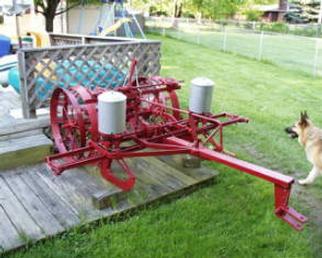 International Harvester 2-Row Planter - Unknown IH year and model. May be a mixed breed. Cleaned and painted in 1995. The planter was functioning in 1995. The left planter can is original. I fabricated the right one. Planter can lids are original. Fertilizer portion is shot. Markers are at my farm. Planter is in Indianapolis. Still have rusted out fertilizer cans. Have a total of 3 sets of seed plates. Approximate weight 500 pounds.