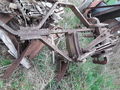 3 PT. Mounted Plow - Oliver Or John Deere - The 3 pt. hitch connects to the tractor  and sways as much as the arms sway. The  plow itself pivots on the hitch. This  photo shows it all the way to the right.  The top link is out of view in this photo  above the 2 parallel bars. Another  hydraulic cylinder goes from just behind  the top link to the mount behind the 2  parallel bars. I am clueless about the  spring. I have never used the plow.