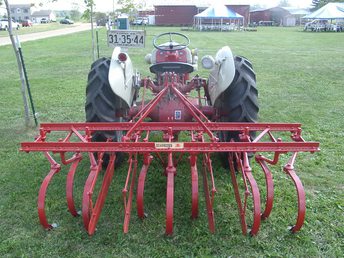 1948 Dearborn 13-2 Spring Shank Cultivator - My 1948 Ford 8N (built on October 14, 1947)restored and all gussied up getting ready for a local fall farm festival. With her is my 1948 DEARBORN 13-2 Spring Shank Cultivator, restored as well. The crop shields are moved to the rear of the implement so they don't hit the tires. In normal use, you would move the front axles out one notch and reverse the rear tires so you could straddle two rows. Then the crop fenders/shields would be attached to the front of the implement. Included but not shown here is the original row marker that bolted to the right front axle to help guide the tractor down the crop rows. Also available as an option was side dresser that had two hoppers and a drive wheel for planting seed or dropping fertilizer. Pittsburgh Forging Co, Detroit, MI supplied the cultivators to Dearborn Motors.