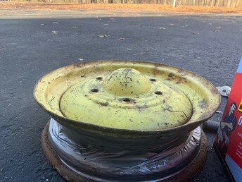 ? - This is from a small trailer. Someone painted it  green and yellow, but I do not believe that it is  from John Deere. I need some help finding rims for  it. It has a 16' 6 bolt 7 inch circle pattern. This  is extremely hard to find. Has anyone seen a rim like  this? I can not replace the hubs with more  traditional patterns because it has a 1.5' non- tapered spindle.