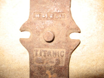 Unknown - there was a junk yard where this was found in the 1920's. I have found many old car parts.Scripps Booth, Ford, Dodge Bros. ect. This was dug up by a woodchuck, yocan plaily see Titanic cast into plate, plate is about 4 1/2 inchs by 3 inches  there appears to be counter sunk opennings for screws or flate head bolts on one side.I am told there was also old tractor junked there also. Junk yard was cleaned out during WW2.