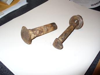 Allis Chalmers WD - Wheel Weight Bolts - Large bolt on the left comes from the rear weight. The smaller bolt on the right comes from the front wheel. Notice that both are carriage bolts, but the front bolt has one side of the head ground down to fit into the slot in the front wheel.