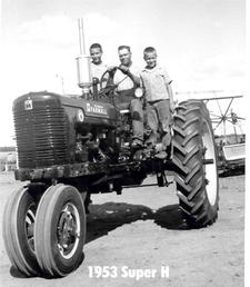 1953 Super H (New From Dealer) - Sauk Centre, Minnesota. My self on the left, Dad driving and my younger brother on the right. Dad just drove the Super H home from the dealer, Jack Smith IH in Sauk Center. Broke the tractor in on the grain binder you see to the right of the tractor. Then it went on the threshing machine. Dad shock threshed for 6 of the neighbors and then stack threshed several more. I spent many, many, many hours on this tractor!