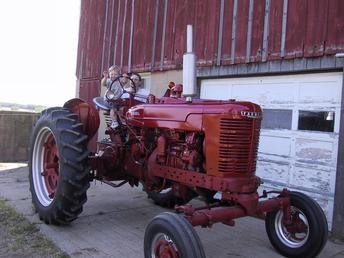 1950 Farmall MD - My 3 yr. old grandson driving the MD? Still in the restoration stage. See more about this MD in the picture below.