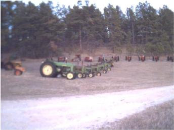 Row of John Deeres R through H - This is part of my collection lined up along the lane. The far line is Case. We all can spot a John Deere ....