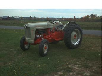 1954 Ford 640 - I bought this tractor last sping (2001)I spent many eves (after work ) and weekends, working on it . I enjoyed it very much. I sanded and sandblasted praticaly everything on it to bear metal.Its been primed with 2 stage primer and painted to its original colors.IT has a completely new 12 volt ignition. Also new starter switch, coil front tires, exhaust, hood emblem, decals, steering wheel, shifter boot and knob, all filters and fluids, complete P.T.O. Shaft kit, The tractor has a low serial number that makes it a 1954.It runs, drives, and the hydrolics work verygood. The tractor is close to a show tractor.I am very happy with the way my first tractor restoration came out.Thought I would finally send in a picture of it .Thanks for looking and all your past help, this is truely a great tractor site with very much info. Thanks again....P.S. the tractor also now has new lights on it ...