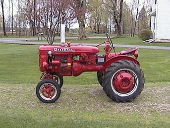 1950 Farmall Super A - Purchased 2002. Newer paint, new rear seals, no leaks, great tires. Runs well, used every day to 'putz' around the farm in Parma, Michigan. Came with a Woods mowing deck. Missing battery box, front emblem, and a crank (did these come standard with a crank for emergency use?).