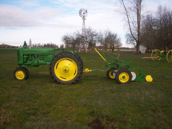1949 John Deere M.T. - I just finished restoring this tractor,and  plow. The decals are missing in the  picture,but are now installed.