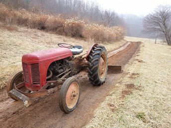 Ferguson - My neighbors tractor, still a little wet to be grading, but this winter has messed up all of our roads and driveways. Any way to tell the year from this photo?