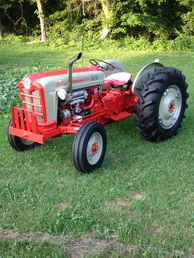 1961 801 Ford Power Master - Bought this tractor from a farmer that was retiring  one like my dad had but couldn't locate his so I  bought this one always thought they were the  prettiest tractor ford ever built was in pretty bad  shape when I bought it so I restored it myself  completely first time I had a paint gun in my hand  but it turned out pretty well.