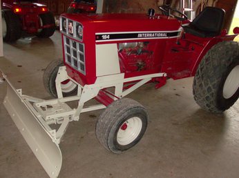 1977 International 184 -  I bought this tractor restored. It has the 3 point hitch and the creeper gears and it came with the blade and a mower deck.