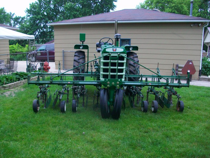 1964 Oliver 770 Gas - 1964 Oliver 770 gas tractor with a square fenders and narrow front. Restored. Has a Model 640, 4 row, front mounted cultivator on it.