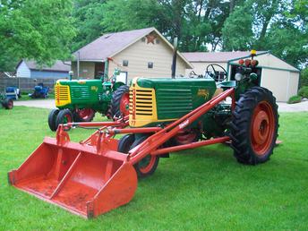1953 Oliver 77 Diesel And 1949 Oliver 77 Gas - 1953 Oliver 77 diesel and 1949 Oliver 77 gas with loader. The 1953 has a sickle bar mower behind it.