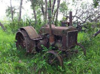 John Deere D - A site that would make a tractor hunt  interesting,  an originally owned John  Deere 'D' on steel still sitting in the  bush on the original homestead.
