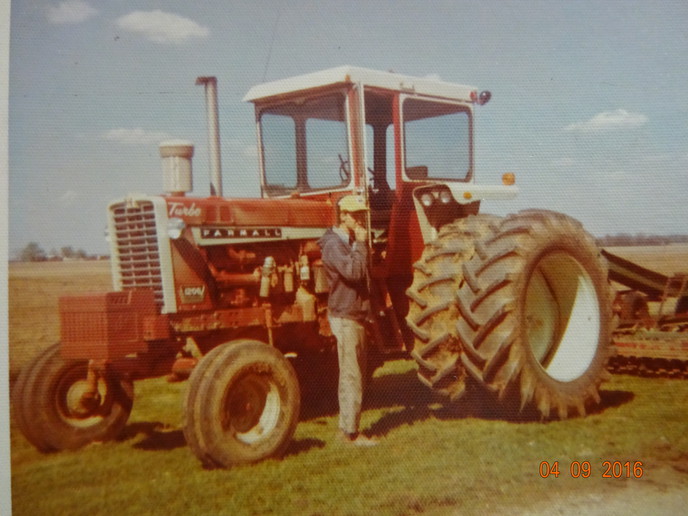 Farmall 1206  #8350 - My first tractor 1967 1206 SN 8350 bought used at Halstead Imp. Co. with 1250 hrs in 1969 for 6,900.  Had Year Around Cab within the fenders, no AC.  Was a 5 and 6 bottom plow tractor then, plowed beside a 1256 and 1456.  Local IH mechanic adjusted pump on dyno to stay with the big dogs.  This is an old picture from Grandma's old little Brownie camera.  I'm eating lunch while pulling the Brillion cultimulcher.