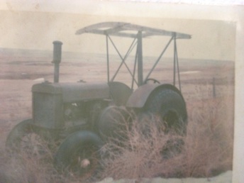 1930 John Deere D - I just acquired this picture with the actual tractor just a few days ago. I seem to think seeing this picture on this site a few years ago. Has anyone else seen it or am I crazy. The canopy is what I remember most. Also I was told this picture was taken in Texas and the tires on the back are B-29 bomber tires. Thanks for any help.