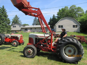 1960 Ford Model 1821 - Original tractor with elenco front  driving axle, sherman transmission, ford  712 loader, cable steering, cut-a-way  (half moon shape) steering wheel.
