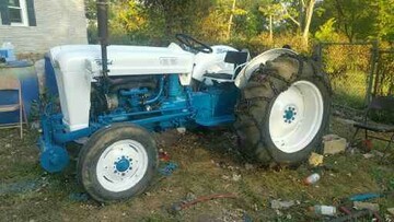 1953 Ford NAA - I purchased this tractor in 1974 and did a complete  restore that included a 12 volt conversion. It got  another face lift in 2002 due to faded and peeling  paint. It got another face lift in 2019 to stop sheet  metal rusting. Did a complete color change from  red/gray of 45 years of my ownership, to the modern  blue/white Ford colors. I used the left over paint  from the 4000 restore. New red/gray was just way too  expensive. Still adapting to color change, but it  don't look half bad.