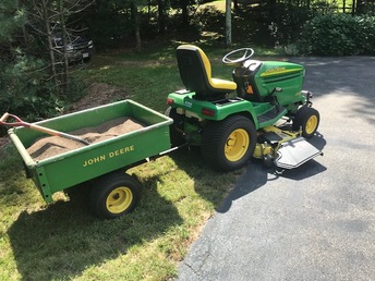 2004 John Deere GX335 - Original owner was a John Deere dealer  in the Tampa Florida area. Have no idea  how it made it's way to Massachusetts,  but I am very proud to be it's current  owner. Pictured here with a Model 80  dumping cart.