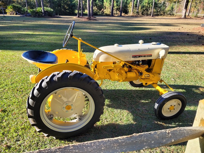 1965 International Cub Lo Boy - This is a tractor that my Dad bought when  I was about 10 years old (about 1972). We  cut the grass and managed our garden with  it. He passed away in 1993 and I ended up  with it at my house in 2016 when we had to  move my mom out. I started the restoration  in late 2020 and finished it in November  of 2021. The engine was locked up so I  rebuilt it completely, sand blasted it  down to the bare metal and painted it back  to its original colors. Dad would be  proud. Thanks to Yesterdays Tractor for  all of the parts I needed.