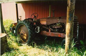 1949 Massey Harris 44-6 (As Found) - This is where I found the tractor, sitting alongside the bark for 30 years. It had a stuck engine, but everything was all there.