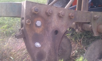 2 Bottom Moldboard - Broken Spring? - The front Moldboard tripped on a large  rock. It won't un-trip... I pulled part  of it apart and need a new spring, but I  can't figure out where it attaches and  if there's a shear bolt. I have other  photos.  <P>Any idea what kind of plow this is?  Closest I can find is John Deere F120  because it has the 4 bolts across the  top. On the back guide wheel is stamped  (no guarantee the wheel belongs to the  set; the coulters are from another  plow).