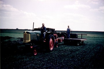 1951 Oliver 77 Row Crop - Great grandpa Nels on the 77, not sure  who's on the cart.  You can also see  Grandpa Norlin's Oliver 70 Row Crop in  the background.