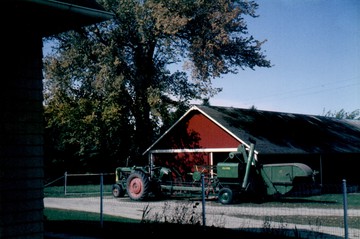 1951 Oliver 77 Row Crop W/ 18 Combine - The 77 parked in front of the machine  shed.  Hooked up to the model 18 Oliver  combine.  Photo taken Sept. 1965.
