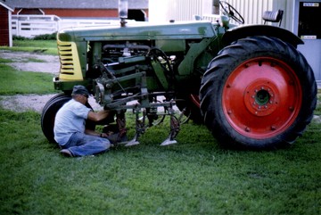 1951 Oliver 77 Row Crop W/ 2 Row Cultivator - My grandpa Ray working on the 2 row frame  mounted hydraulic cultivator.  Photo  taken June 1973.