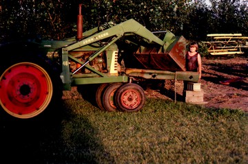 1951 Oliver 77 Row Crop - Looks like Dad was using the old 77 to  part out an 88.  That's my brother Kirk  standing next to the bucket.