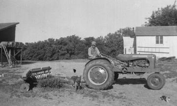 Early 40S Allis - My dad on his almost new Allis Chalmers tractor with a straight disc.  The dog in the picture was named Rex and was a very smart dog.  Taken in 1944 or '45