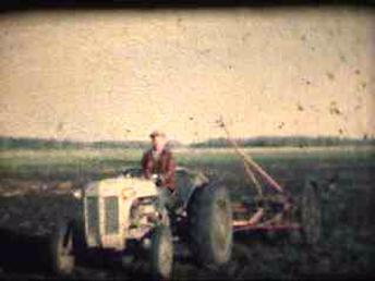 1940S Ferguson Pulling - Spring time in late 40's.  My grandmother on the tractor pulling the cultivator.  My grandparents purchased a Co-op E-4 in 1951 and since they could pull this cultivator in 5th gear, they did!