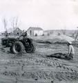 A Farmall/Fresno - This is a pic of my dad and aunt on an A Farmall tractor and my grandad operating a fresno, moving dirt to build a new house in 1950