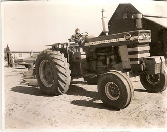 Massey Ferguson 1100 Diesel -  Me sitting on the tractor, about 1969 at the Bismark farm in Stanchfield Minnesota, pretty sure that is uncle George Bismark standing by Dad's car, wish I had that tractor today, Dad has one but this one would be good to have again 5/16 plow behind it sitting in front of the grainery facing south, was a pretty good tractor