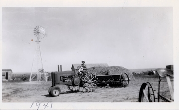 1941 John Deere A Styled On Steel - Taken in 1941 near McCook, NE showing my father and my oldest brother. The JD A was bought new that year and we used the drill up thru the 1970s. The A was used up to the late '70s along with a 1944 A, 1939 9N, Massey 44 gas and a Massey 55 Diesel. The pictured tractor was later fitted with rubber drive tires. I put in quite a few hours on all of our tractors and now own a 1949 Ford S/N 8N203957 and a 1959 Ferguson TO35 Deluxe gas S/N SGM196854. My co-workers think I'm nuts to be involved with old tractors. They'll never know how much enjoyment I've gotten from using and working on these relics.