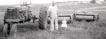 1949 Farmall H - This is my grandfather and his daughter (my aunt) with his tractor and bluegrass stippers.  He bought the tractor new and was his first tractor.  The tractor has always been in the family and I've spent the last 2 years restoring it.