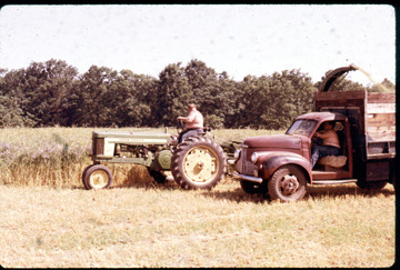 1957 John Deere Model 520 - This picture was taken in Bellingham MA, in the early 60's. The farm down the street hayed our property. Don't know the year or make of the truck.
