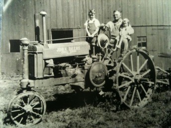 1937 A John Deere - This '37 A was bought new by my great grand father, Everett Dillon. Pictured with him my Uncle Roy Dillon and my mother Emmis (Dillon) Campbell. The A is still in the family and has been completely restored and is now owned by my cousin Terry Dillon.