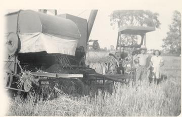 1948, Allis Chalmers WC With All Crop 60 - My Grandfather is on the right and my Great Aunt on the left, This WC has an aftermarket cab. I dont know if any are still around or not, this cab had removeable side curtains for summer.