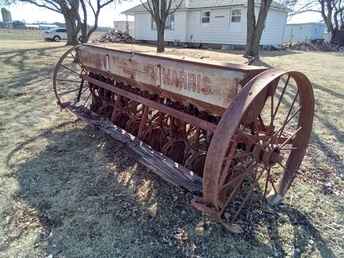 Massey Harris Grain Drill - Massey harris grain drill on  steel,9ft 6in wide, double disc with ~nl~grass seed, stored inside, good ~nl~shape, call thanks